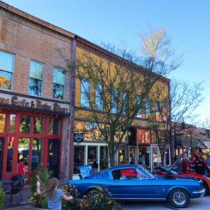 Classic cars parked in front of businesses on the square in Ozark, Missouri