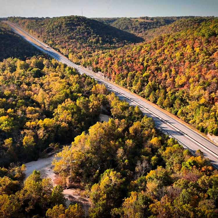 Highway 65 with dense forests on both sides of the road